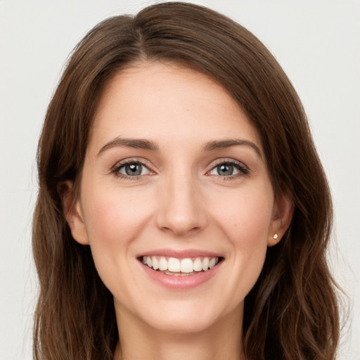 Joyful white young-adult female with long  brown hair and green eyes