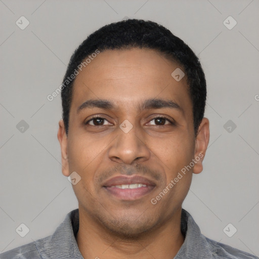 Joyful latino young-adult male with short  black hair and brown eyes