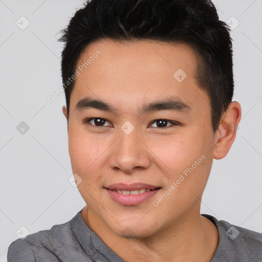 Joyful asian young-adult male with short  brown hair and brown eyes