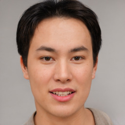 Joyful asian young-adult male with short  brown hair and brown eyes