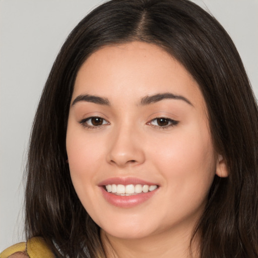 Joyful white young-adult female with long  brown hair and brown eyes