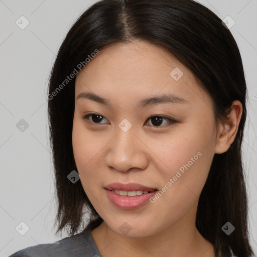 Joyful asian young-adult female with long  brown hair and brown eyes