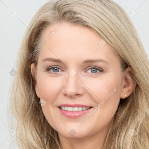 Joyful white young-adult female with long  brown hair and blue eyes