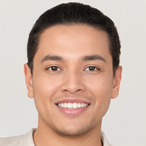 Joyful latino young-adult male with short  black hair and brown eyes