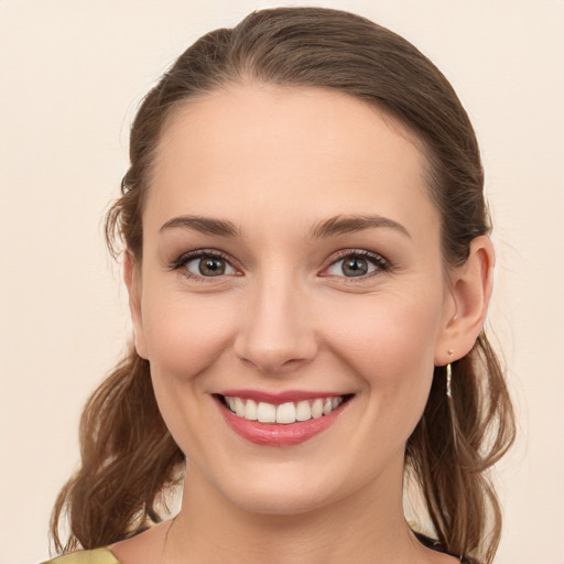 Joyful white young-adult female with long  brown hair and blue eyes