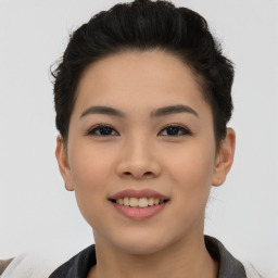 Joyful asian young-adult female with short  black hair and brown eyes