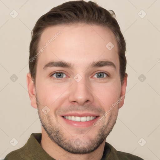 Joyful white young-adult male with short  brown hair and grey eyes