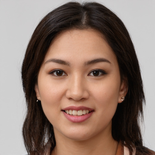 Joyful white young-adult female with long  brown hair and brown eyes