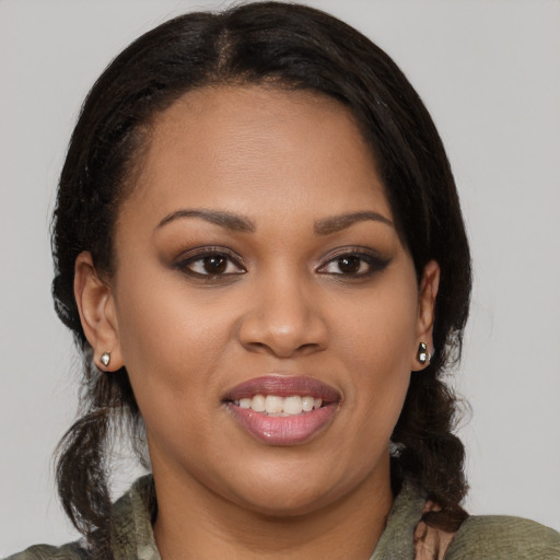 Joyful black young-adult female with medium  brown hair and brown eyes