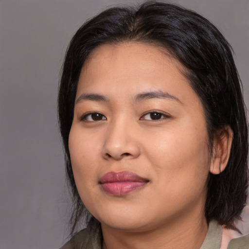 Joyful asian young-adult female with medium  black hair and brown eyes