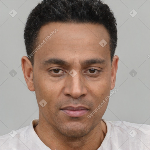 Joyful latino adult male with short  brown hair and brown eyes