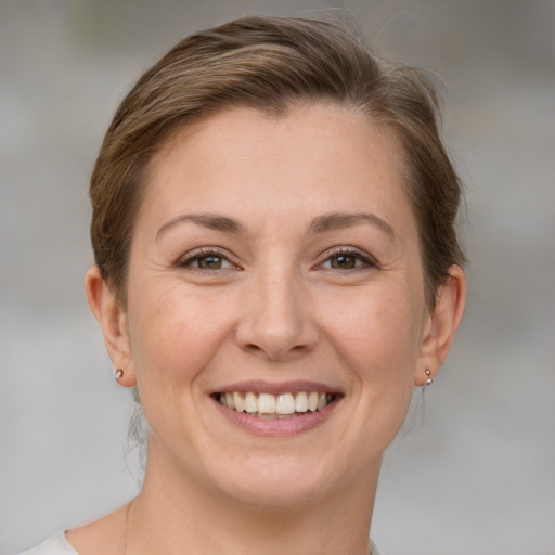 Joyful white adult female with medium  brown hair and brown eyes