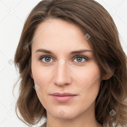 Joyful white young-adult female with medium  brown hair and green eyes