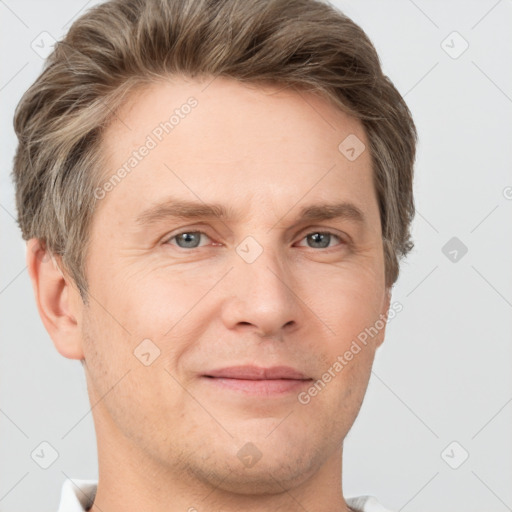 Joyful white adult male with short  brown hair and grey eyes