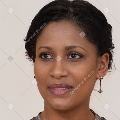 Joyful black young-adult female with long  brown hair and brown eyes