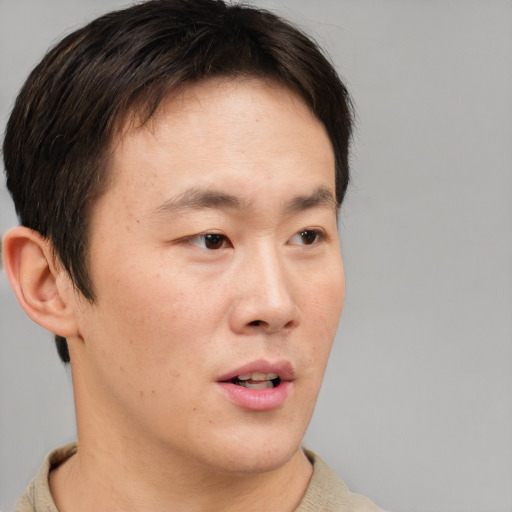 Neutral asian young-adult male with short  brown hair and brown eyes