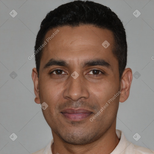 Joyful latino young-adult male with short  black hair and brown eyes