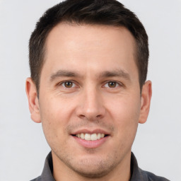 Joyful white young-adult male with short  brown hair and brown eyes