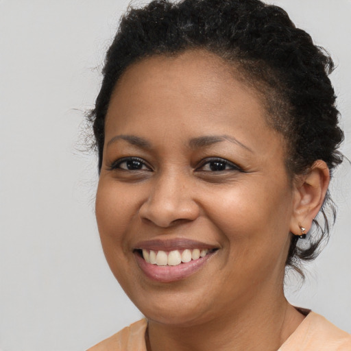 Joyful black young-adult female with medium  brown hair and brown eyes