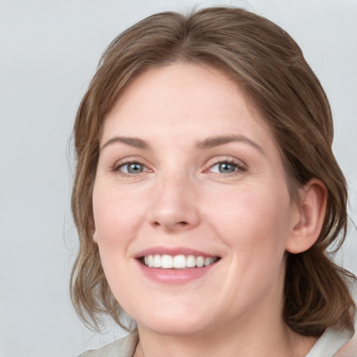 Joyful white young-adult female with medium  brown hair and blue eyes