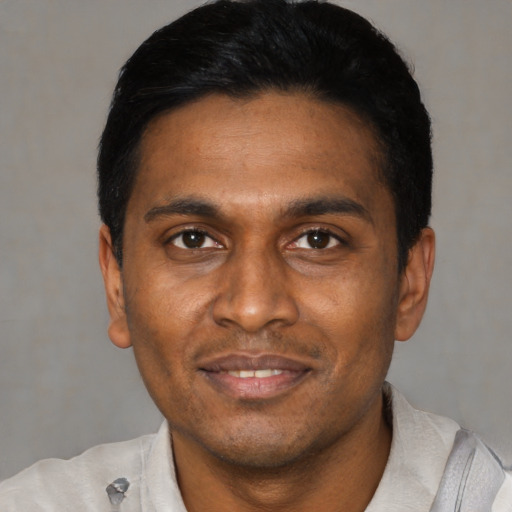 Joyful latino young-adult male with short  black hair and brown eyes