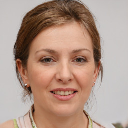 Joyful white young-adult female with medium  brown hair and blue eyes