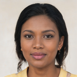 Joyful black young-adult female with medium  brown hair and brown eyes