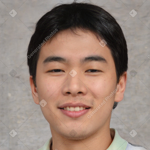 Joyful asian young-adult male with short  brown hair and brown eyes