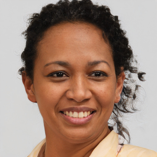 Joyful latino adult female with short  brown hair and brown eyes
