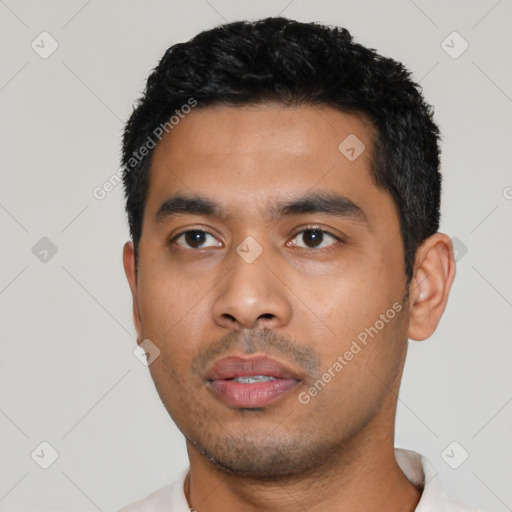Neutral latino young-adult male with short  black hair and brown eyes