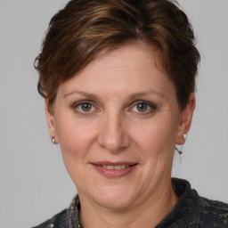 Joyful white adult female with medium  brown hair and grey eyes