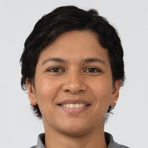 Joyful latino young-adult female with short  brown hair and brown eyes