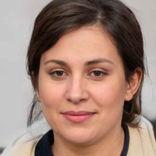 Joyful white young-adult female with medium  brown hair and brown eyes