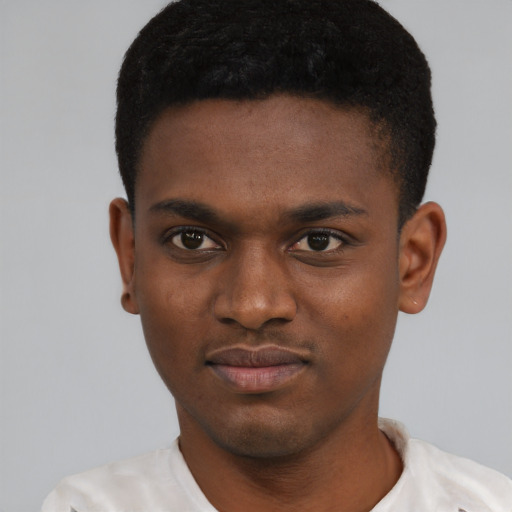 Joyful black young-adult male with short  black hair and brown eyes