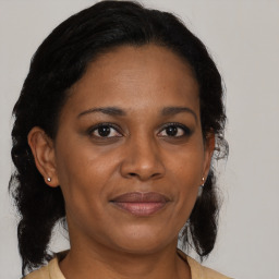 Joyful black adult female with medium  brown hair and brown eyes