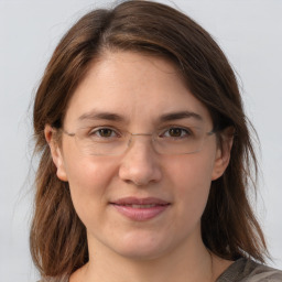 Joyful white young-adult female with medium  brown hair and grey eyes