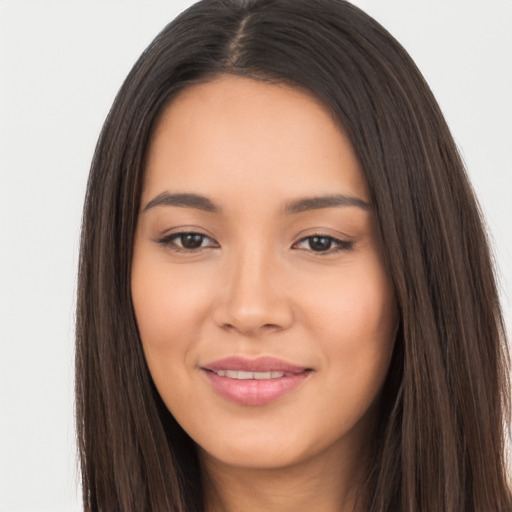 Joyful latino young-adult female with long  brown hair and brown eyes