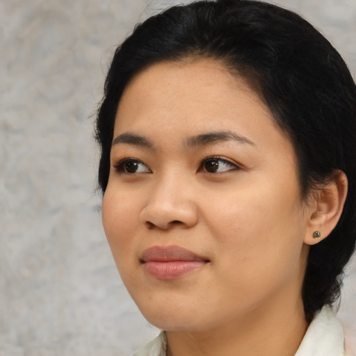 Joyful black young-adult female with medium  black hair and brown eyes