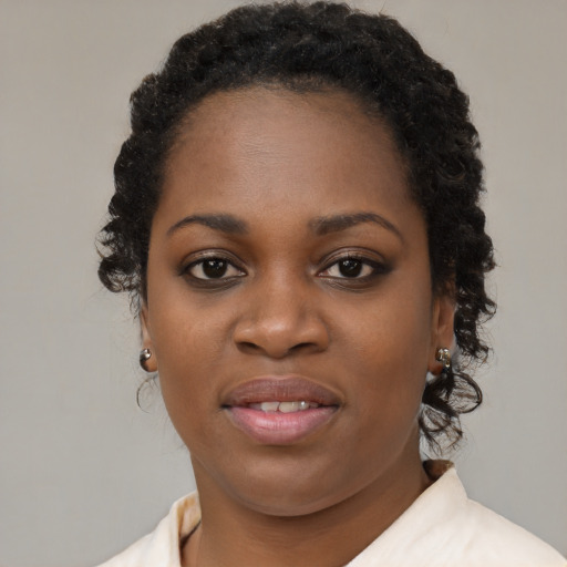 Joyful black young-adult female with short  brown hair and brown eyes
