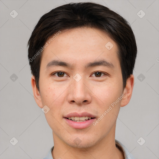 Joyful asian young-adult male with short  brown hair and brown eyes