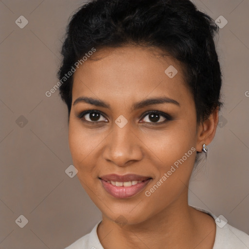 Joyful black young-adult female with long  brown hair and brown eyes