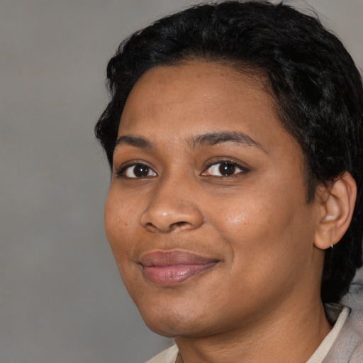 Joyful latino young-adult female with short  black hair and brown eyes