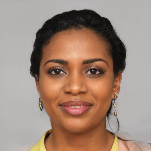 Joyful black young-adult female with long  black hair and brown eyes