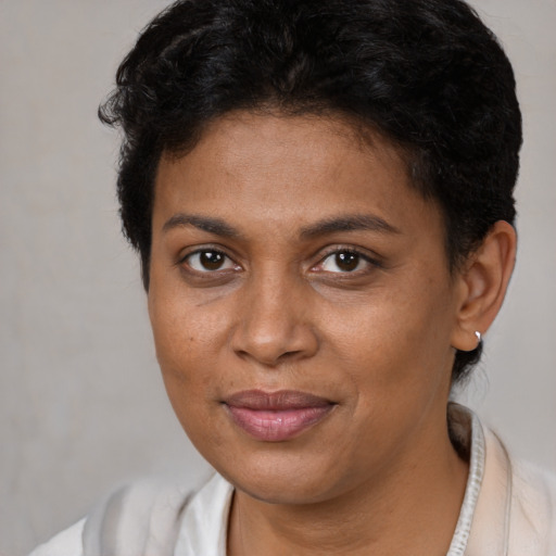 Joyful black young-adult female with short  brown hair and brown eyes