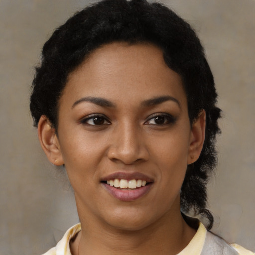 Joyful black young-adult female with short  black hair and brown eyes