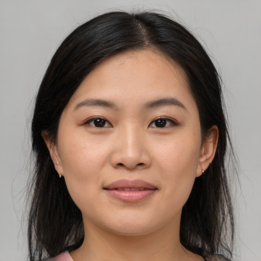 Joyful asian young-adult female with medium  brown hair and brown eyes