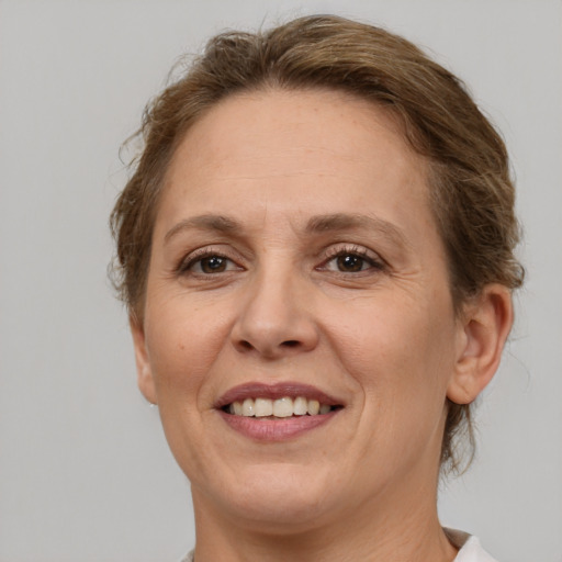 Joyful white adult female with medium  brown hair and brown eyes