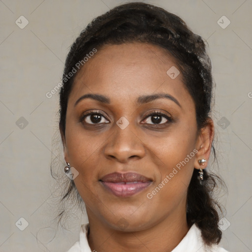 Joyful black adult female with medium  brown hair and brown eyes