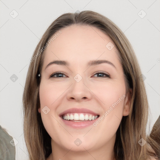 Joyful white young-adult female with long  brown hair and brown eyes