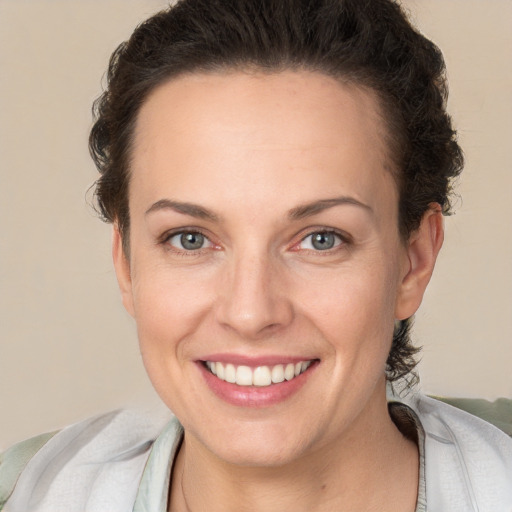 Joyful white adult female with short  brown hair and brown eyes